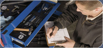 Man Taking Notes on Equipment