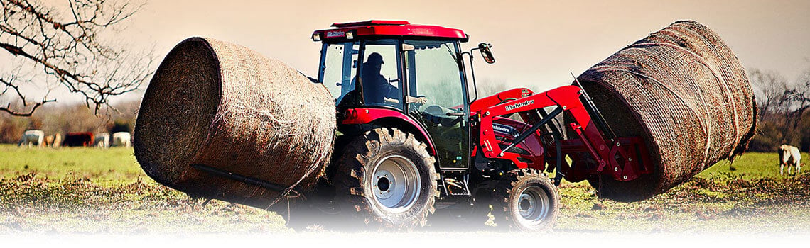 Mahindra Loader Carrying Hay Bales